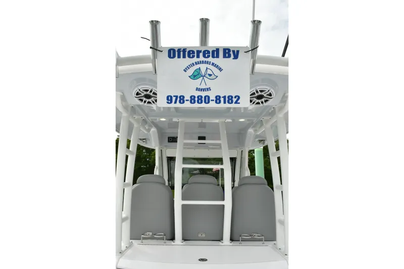 Slide: The Image of 2022 Everglades 335 Center Console boat interior with seating and contact sign. - 18