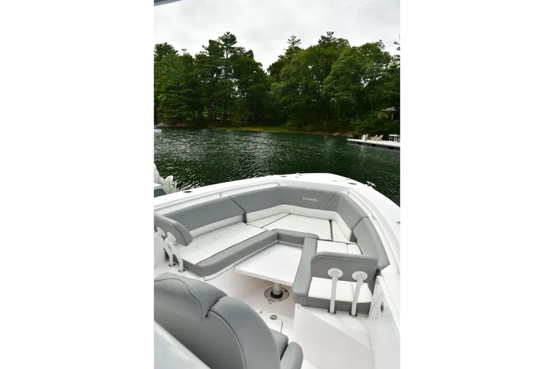 Slide: The Image of 2022 Everglades 335 Center Console boat with spacious seating on a serene lake. - 29