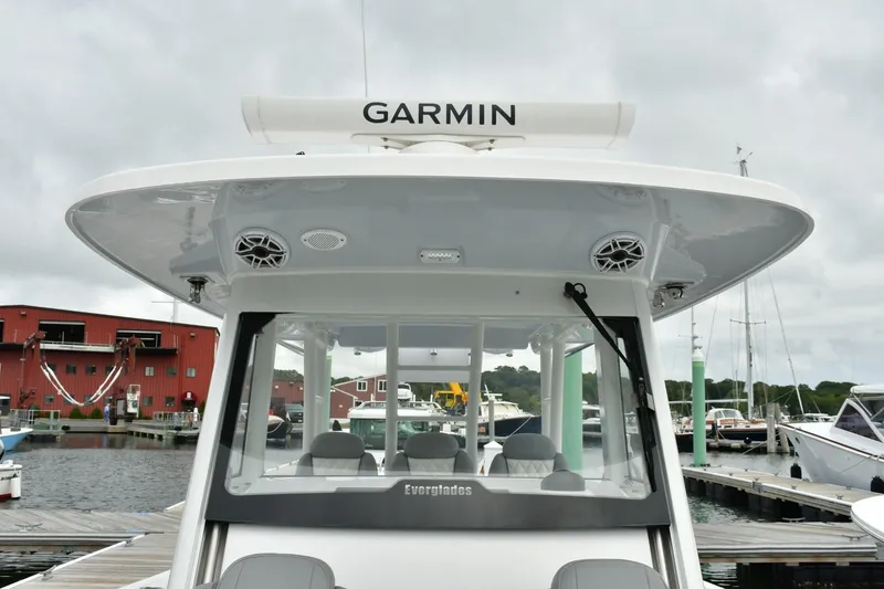 Slide: The Image of 2022 Everglades 335 Center Console boat docked, featuring Garmin equipment. - 32