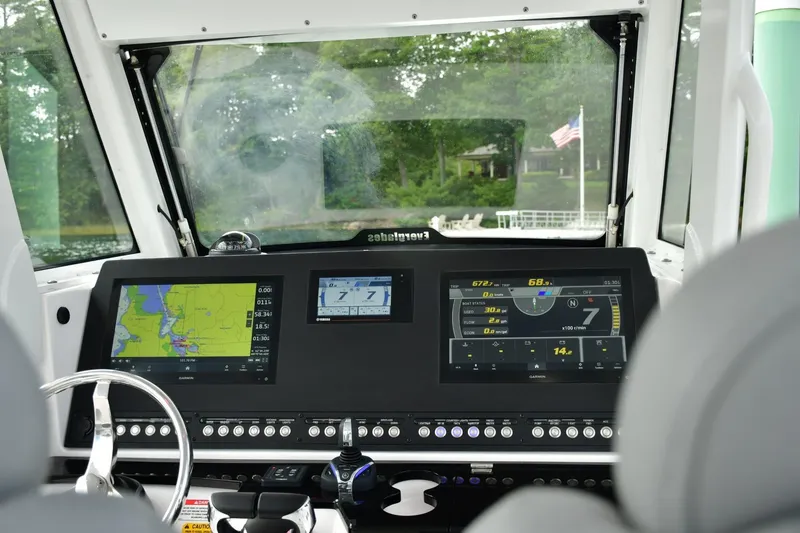 Slide: The Image of 2022 Everglades 335 Center Console boat dashboard with navigation screens and controls. - 8