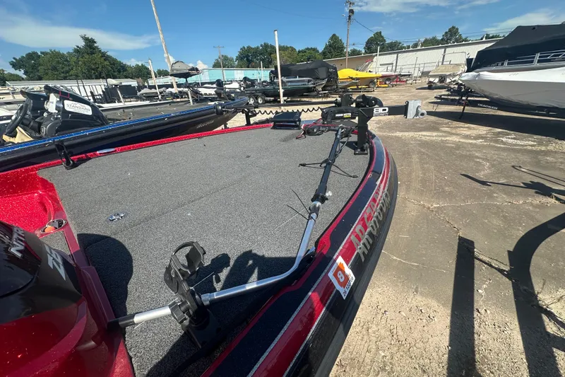 Slide: The Image of 2011 Nitro Z-6 boat with fishing equipment on deck, parked outdoors under clear sky. - 18
