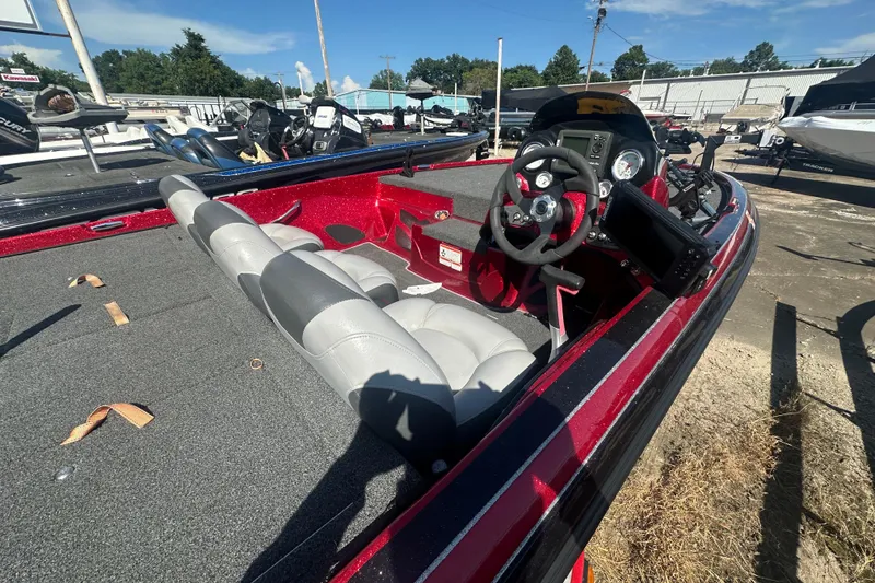 Slide: The Image of 2011 Nitro Z-6 boat interior with steering wheel and seating, parked outdoors. - 20