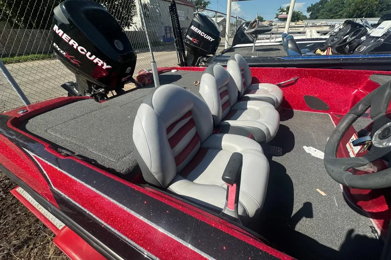 Slide: The Image of 2011 Nitro Z-6 boat interior with Mercury Pro XS engine, featuring gray and red seating. - 21