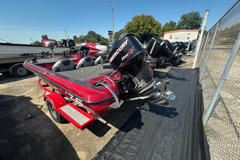 Slide: The Image of 2011 Nitro Z-6 boat with Mercury Pro XS engine, parked outdoors on a trailer. - 3