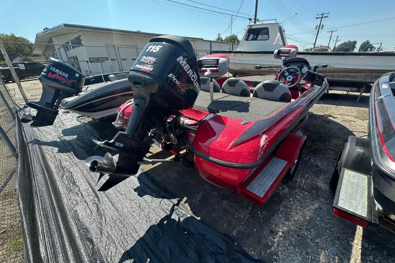 Slide: The Image of 2011 Nitro Z-6 boat with Mercury Pro XS engine, parked outdoors. - 4