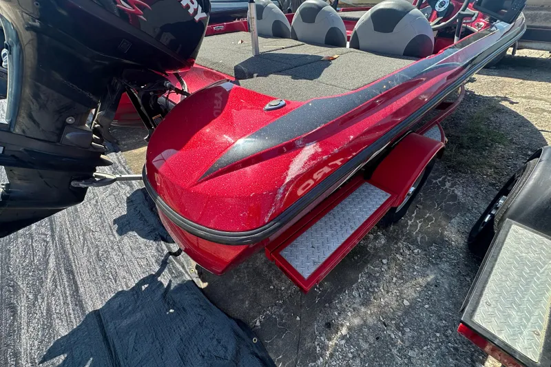 Slide: The Image of Red 2011 Nitro Z-6 boat with Mercury engine, parked on a trailer. - 6