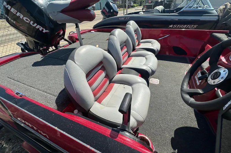 Slide: The Image of 2011 Nitro Z-6 boat interior with gray and red seating, featuring a Mercury engine. - 8