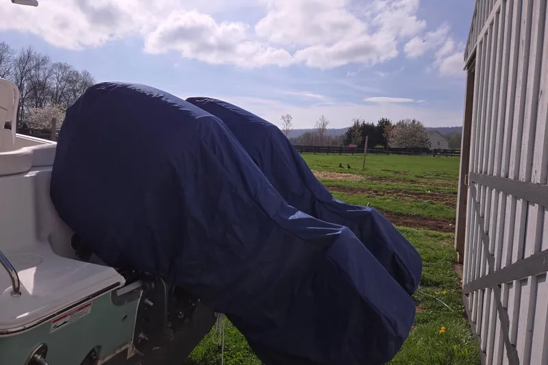 Slide: The Image of 2023 Sea Hunt Ultra 265 SE boat interior with steering wheel and white seating. - 10