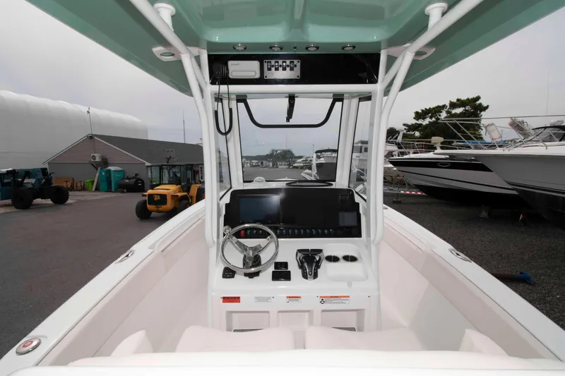 Slide: The Image of 2023 Sea Hunt Ultra 265 SE boat cockpit with steering wheel and control panel. - 14
