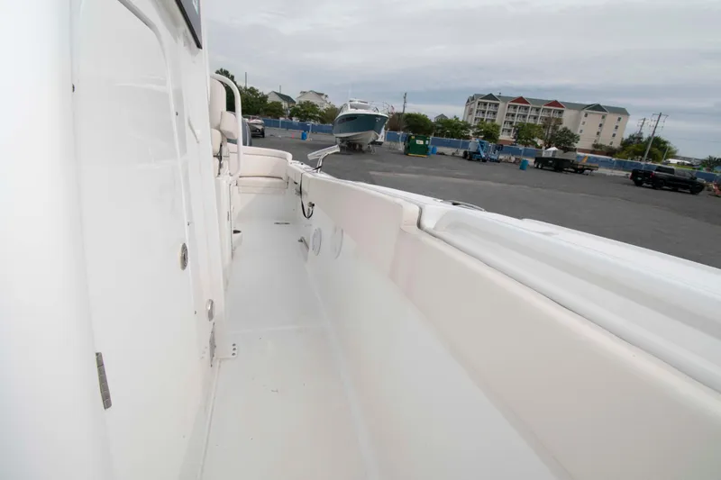 Slide: The Image of 2023 Sea Hunt Ultra 265 SE boat interior view at a marina. - 15