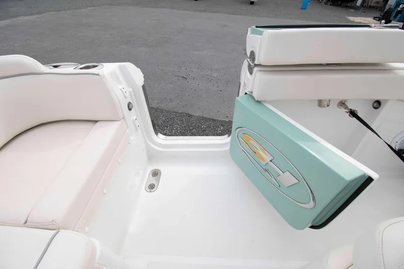 Slide: The Image of 2023 Sea Hunt Ultra 265 SE boat interior with seating and storage compartment. - 16