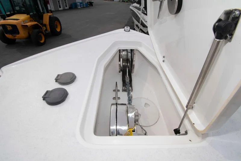 Slide: The Image of 2023 Sea Hunt Ultra 265 SE anchor compartment with winch and chain. - 17