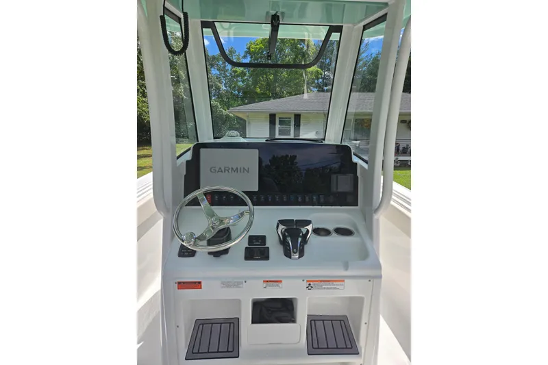 Slide: The Image of 2023 Sea Hunt Ultra 265 SE boat interior with dual engines and white seating. - 7