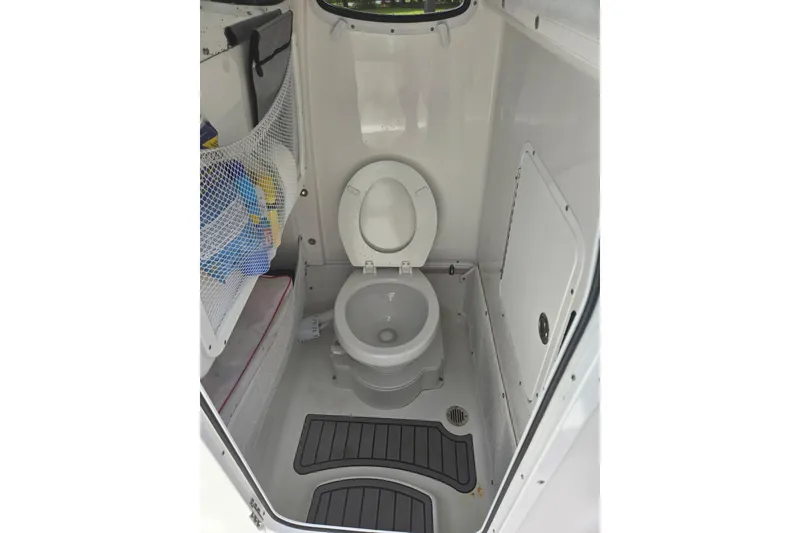 Slide: The Image of 2023 Sea Hunt Ultra 265 SE boat at a marina, showcasing its sleek design. - 9