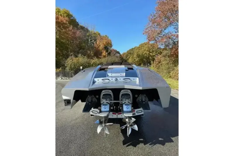 Slide: The Image of 2020 Outerlimits SL-50 powerboat with dual engines, parked on a scenic road. - 14