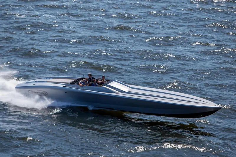 Slide: The Image of 2020 Outerlimits SL-50 speedboat cruising on open water. - 2