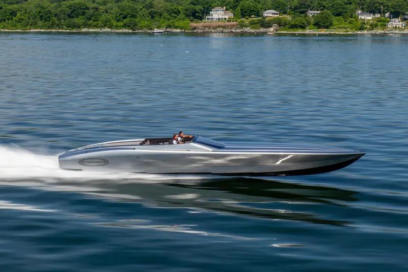 Slide: The Image of 2020 Outerlimits SL-50 speedboat cruising on calm water with scenic shoreline background. - 4