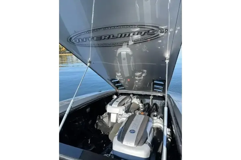 Slide: The Image of 2020 Outerlimits SL-50 boat engine compartment with open hatch on a calm lake. - 8