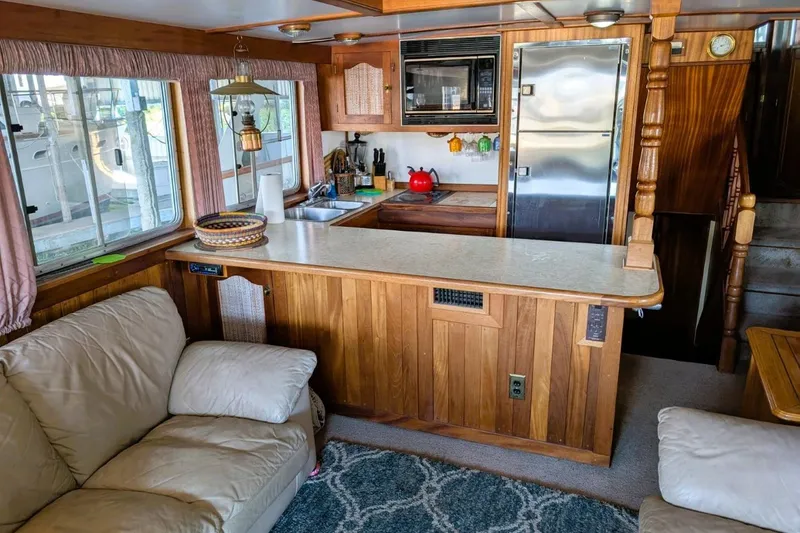 Slide: The Image of Interior of 1989 Custom 52 Pilothouse with cozy kitchen and seating area. - 24