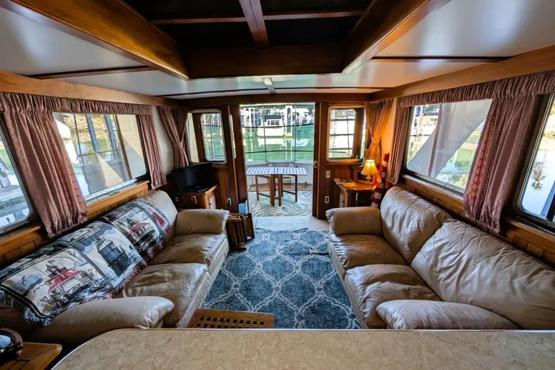 Slide: The Image of Interior of a 1989 Custom 52 Pilothouse with cozy seating and nautical decor. - 26