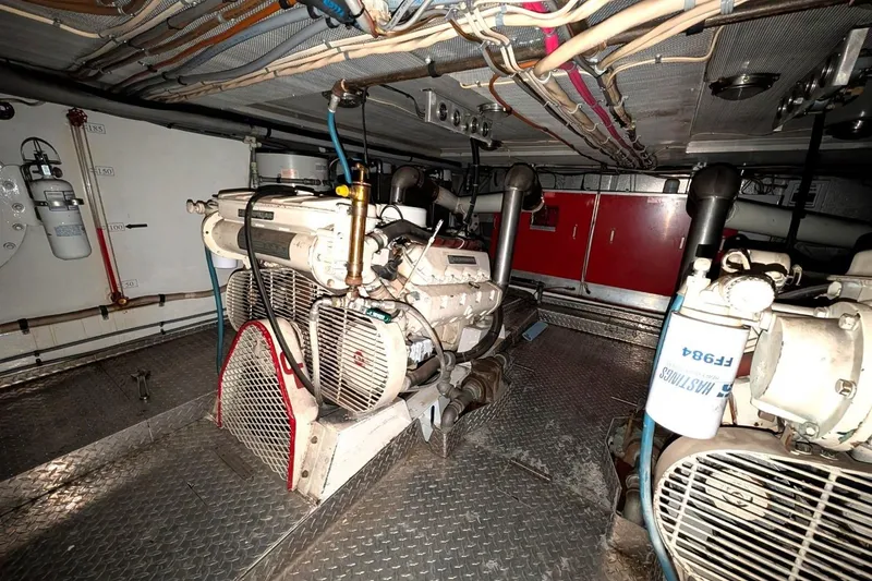 Slide: The Image of Engine room of a 1989 Custom 52 Pilothouse with visible machinery and wiring. - 34