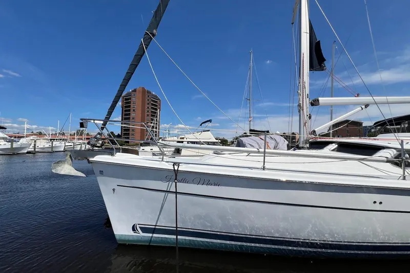 Slide: The Image of Hunter 44 Deck Salon 2005 sailboat docked in marina, clear blue sky background. - 1