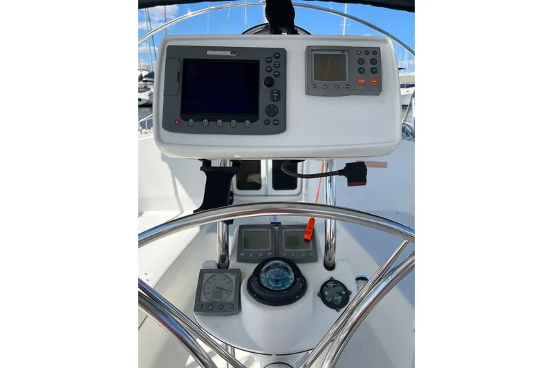 Slide: The Image of 2005 Hunter 44 Deck Salon yacht helm with navigation instruments and compass. - 12