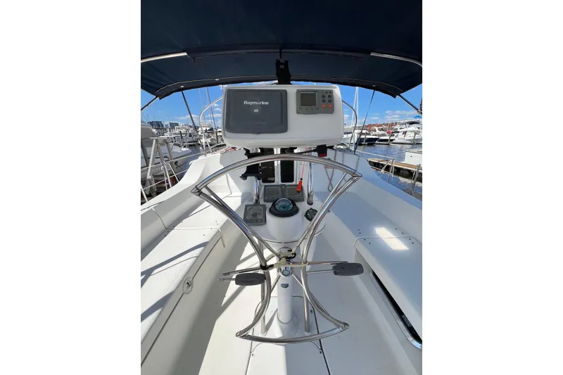 Slide: The Image of 2005 Hunter 44 Deck Salon yacht cockpit with navigation equipment and steering wheel. - 13