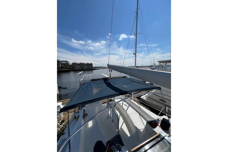 Slide: The Image of 2005 Hunter 44 Deck Salon sailboat docked under clear blue sky. - 16