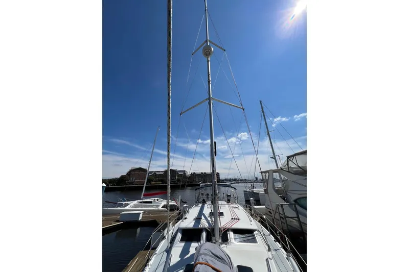 Slide: The Image of 2005 Hunter 44 Deck Salon sailboat docked under clear blue sky. - 19