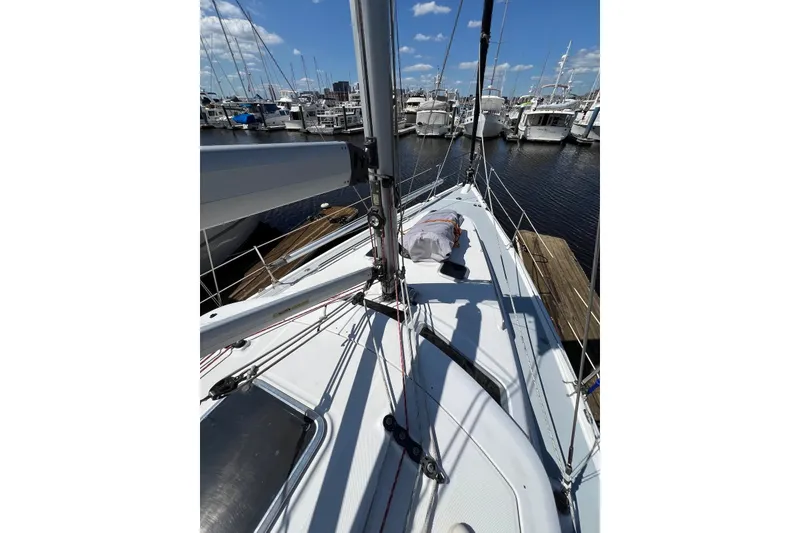 Slide: The Image of 2005 Hunter 44 Deck Salon sailboat docked at marina under blue sky. - 20