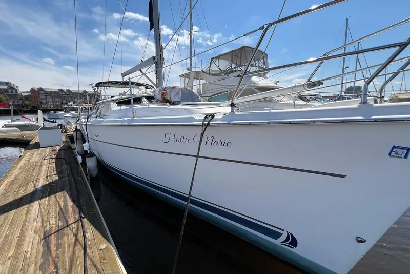 Slide: The Image of Hunter 44 Deck Salon 2005 sailboat docked at marina under clear blue sky. - 21