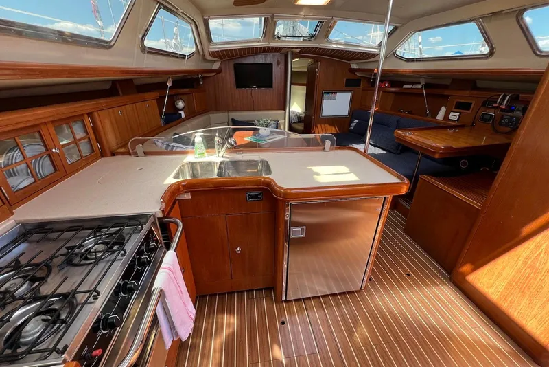 Slide: The Image of Interior of 2005 Hunter 44 Deck Salon yacht with kitchen and seating area. - 29