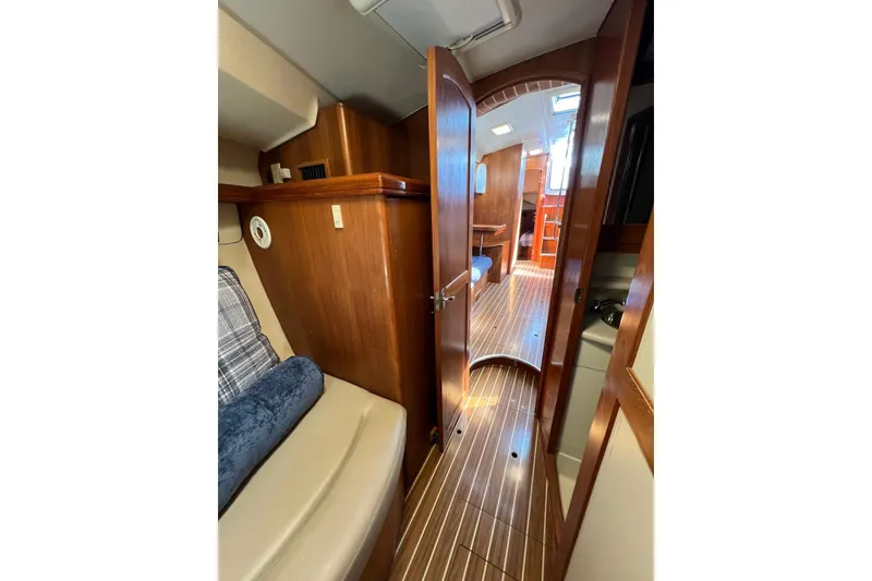 Slide: The Image of Interior of 2005 Hunter 44 Deck Salon yacht, featuring wooden finishes and cozy seating. - 39