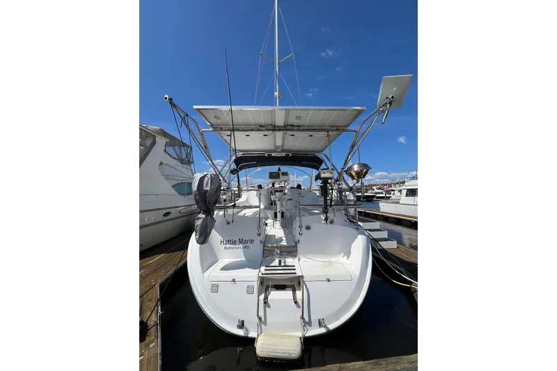 Slide: The Image of Hunter 44 Deck Salon 2005 sailboat docked under clear blue sky. - 4