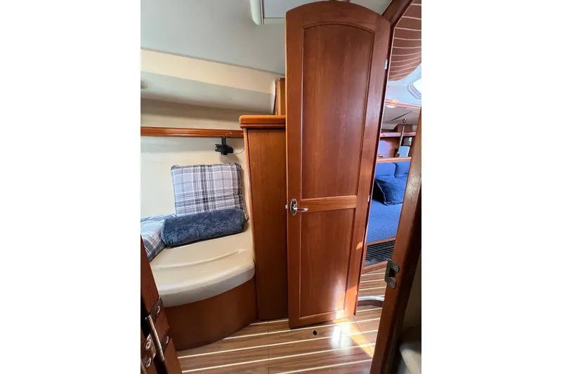 Slide: The Image of Interior of 2005 Hunter 44 Deck Salon, featuring wooden door and cozy seating area. - 40