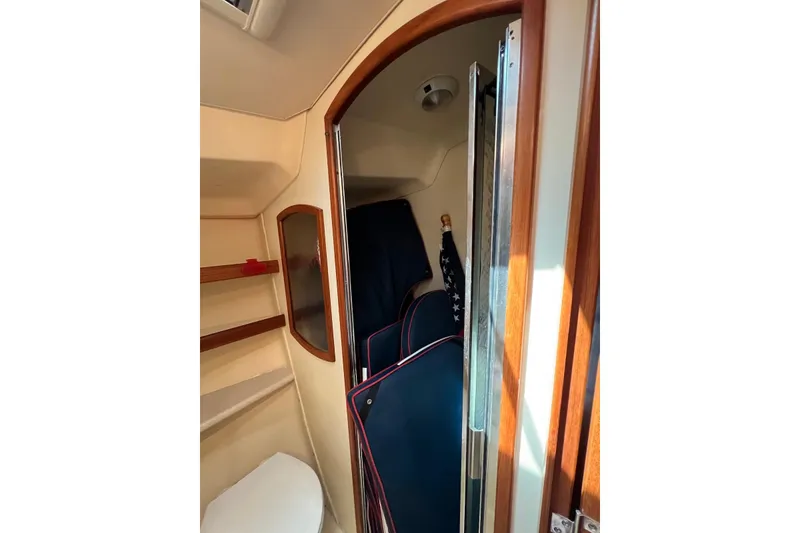 Slide: The Image of Interior of 2005 Hunter 44 Deck Salon, featuring wooden trim and compact storage. - 41