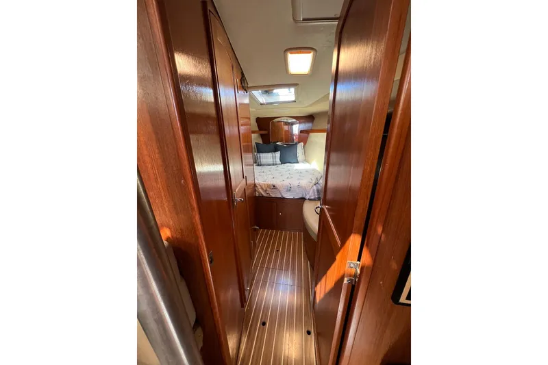 Slide: The Image of Interior of 2005 Hunter 44 Deck Salon, featuring wood paneling and cozy cabin space. - 44