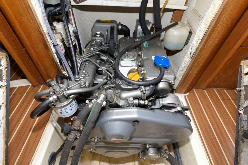 Slide: The Image of Engine compartment of a 2005 Hunter 44 Deck Salon sailboat, showcasing mechanical components. - 50