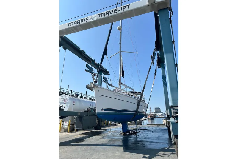 Slide: The Image of Sailboat Hunter 44 Deck Salon 2005 lifted by Marine Travelift at dock. - 8