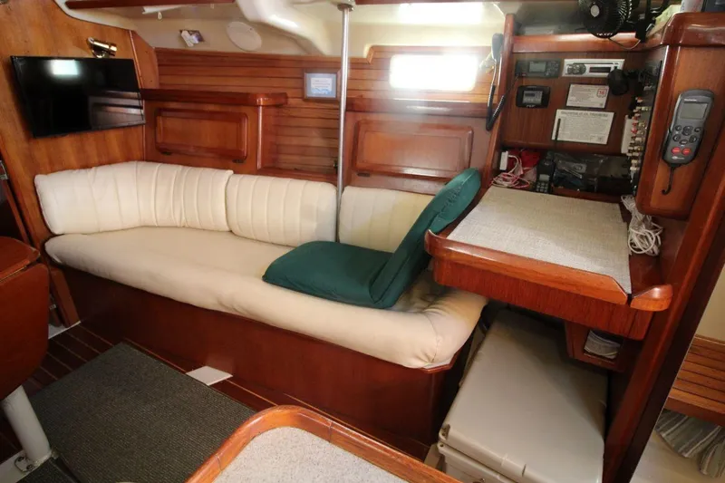 Slide: The Image of Interior of 1991 Hunter 37.5 sailboat with wooden finish and cozy seating area. - 10