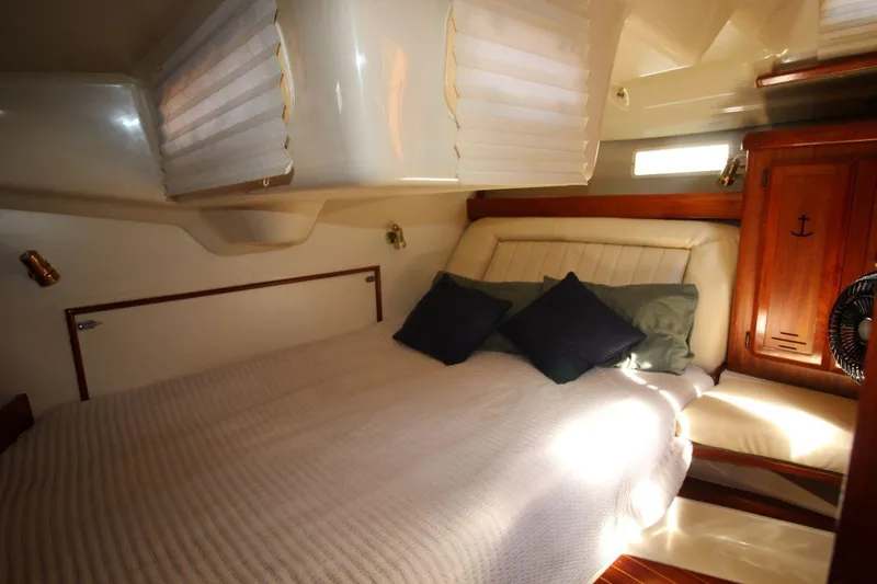 Slide: The Image of Cozy cabin interior of 1991 Hunter 37.5 sailboat with bed and wooden accents. - 12