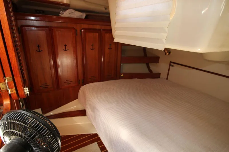 Slide: The Image of Cozy cabin interior of 1991 Hunter 37.5 sailboat with wooden cabinets and bed. - 13