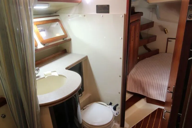 Slide: The Image of Interior of 1991 Hunter 37.5 sailboat featuring bathroom and cozy cabin area. - 14