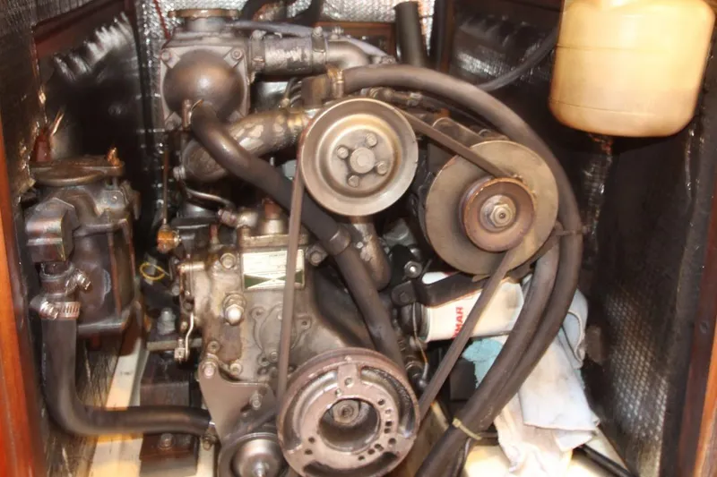 Slide: The Image of Engine compartment of a 1991 Hunter 37.5 sailboat, showcasing mechanical components and belts. - 15