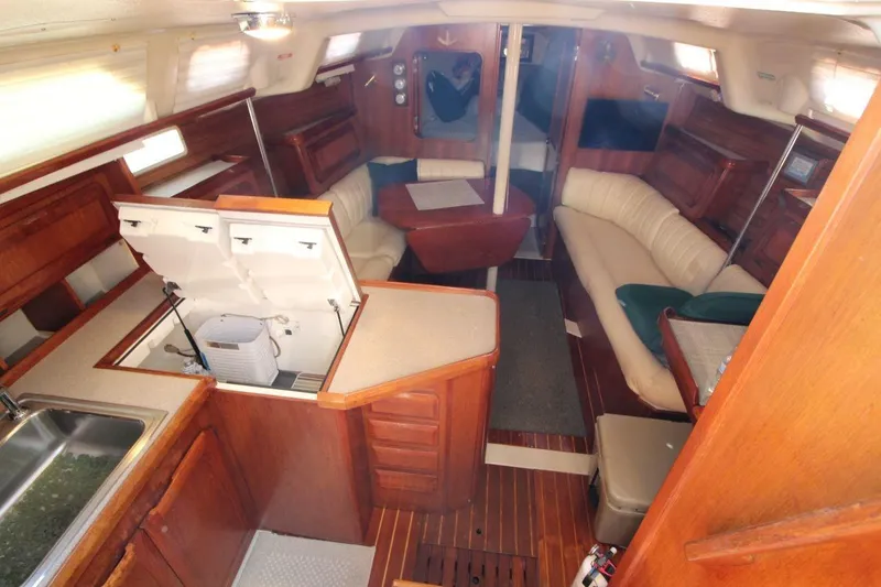 Slide: The Image of Interior of a 1991 Hunter 37.5 sailboat with wood finish and cozy seating area. - 7
