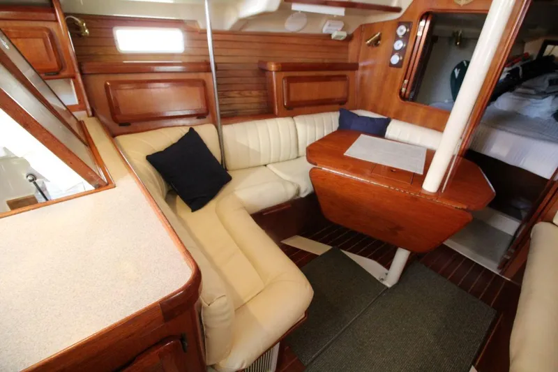 Slide: The Image of Interior of 1991 Hunter 37.5 sailboat with cozy seating and wooden finishes. - 9