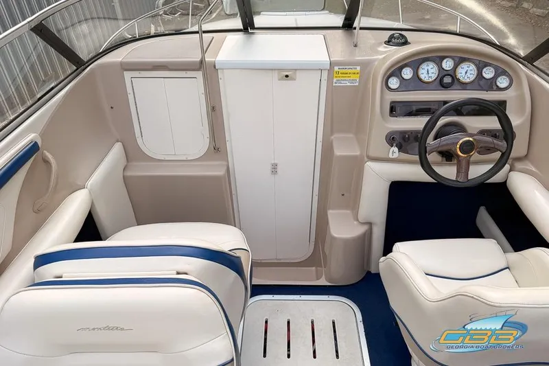 Slide: The Image of 1998 Monterey 236 Montura boat interior with steering wheel, gauges, and seating. - 12