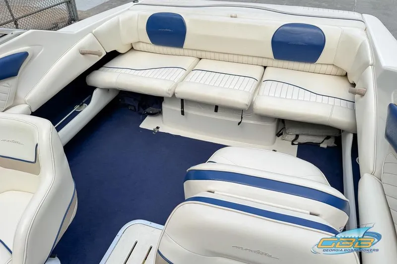 Slide: The Image of 1998 Monterey 236 Montura boat interior with white and blue seating. - 15