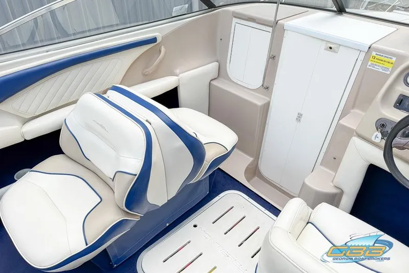 Slide: The Image of Interior of 1998 Monterey 236 Montura boat with white and blue seating. - 16